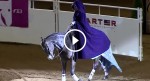 She rides up on a horse, then she removes her cape and STUNS everyone