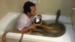 He gets in the bath with two snakes and goes in for a kiss. But watch the one on the right